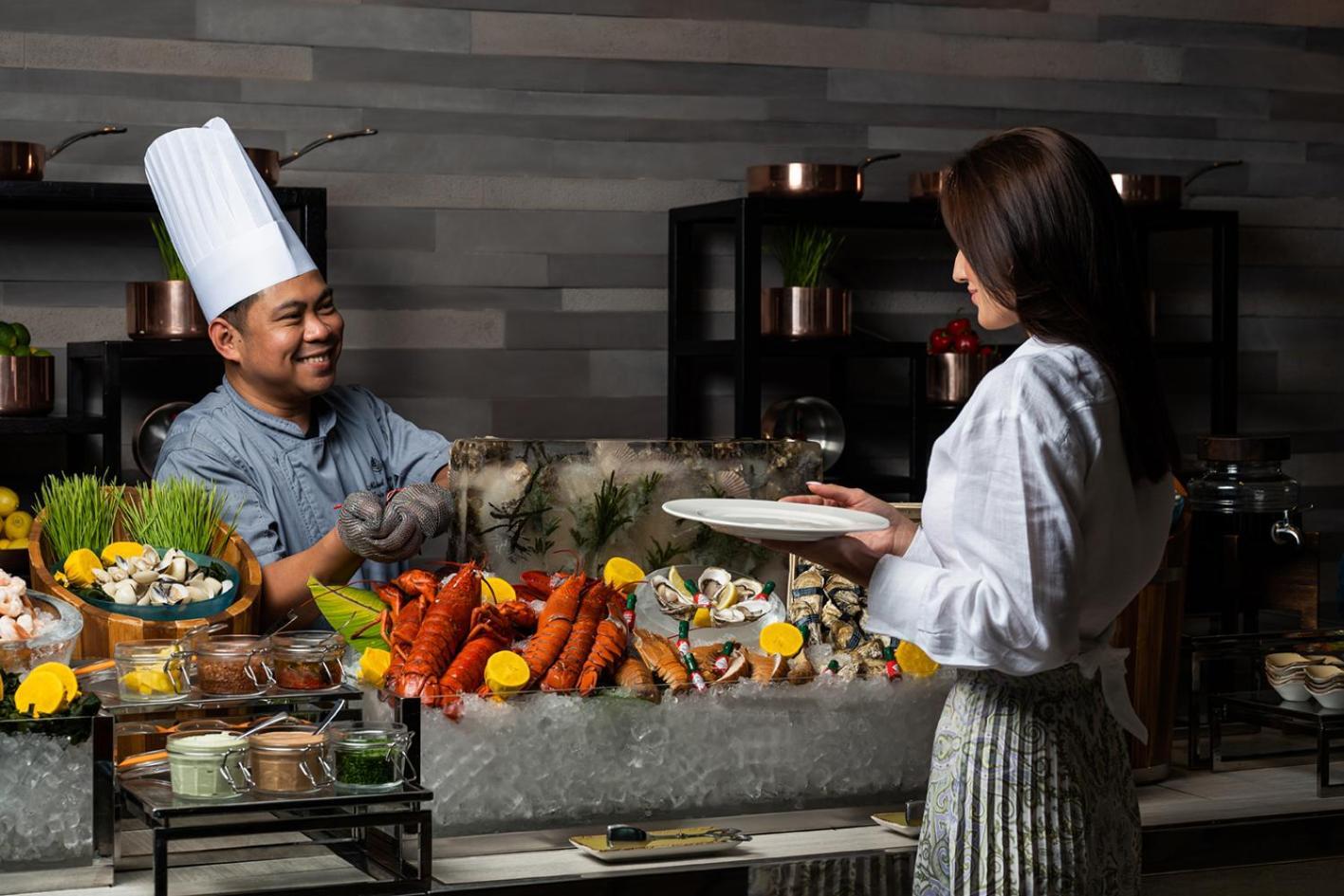 Four Seasons Hotel Abu Dhabi At Al Maryah Island Esterno foto A chef serving food to a guest